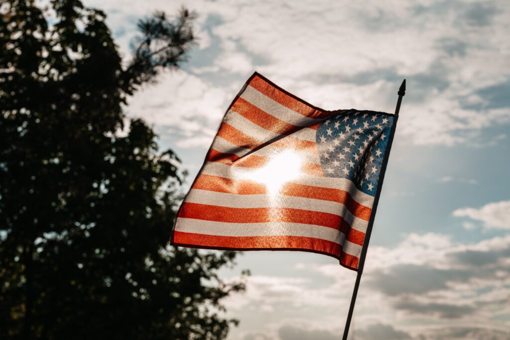 American Flag with sun shining through